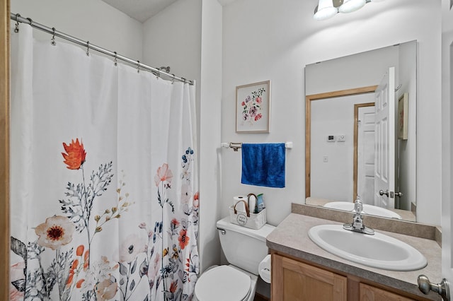 bathroom with vanity, toilet, and curtained shower