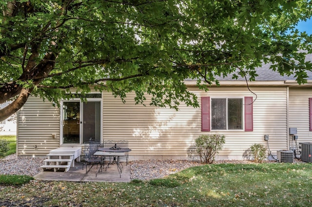 rear view of property with a lawn and a patio area