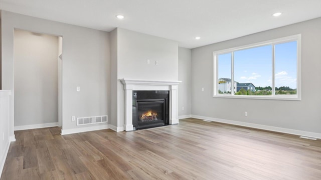 unfurnished living room with light wood-type flooring