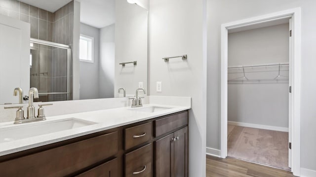 bathroom with vanity, hardwood / wood-style floors, and an enclosed shower