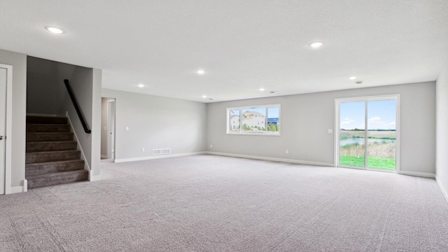 unfurnished living room with light colored carpet