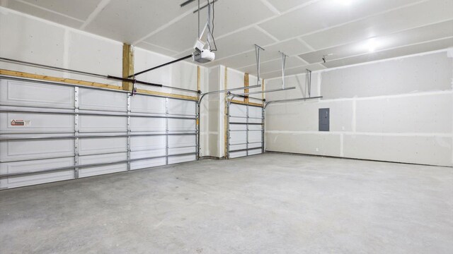 garage with a garage door opener and electric panel