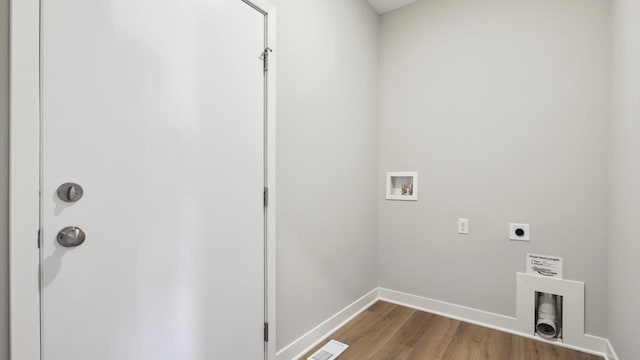 laundry area with electric dryer hookup, washer hookup, and light wood-type flooring