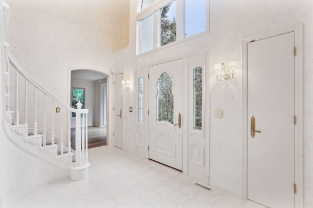 foyer entrance featuring a towering ceiling