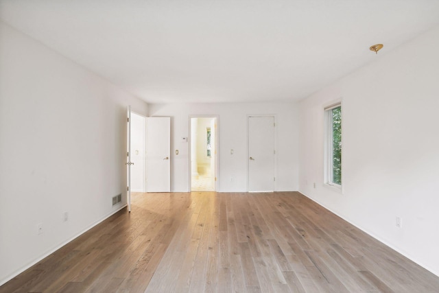 empty room with wood-type flooring