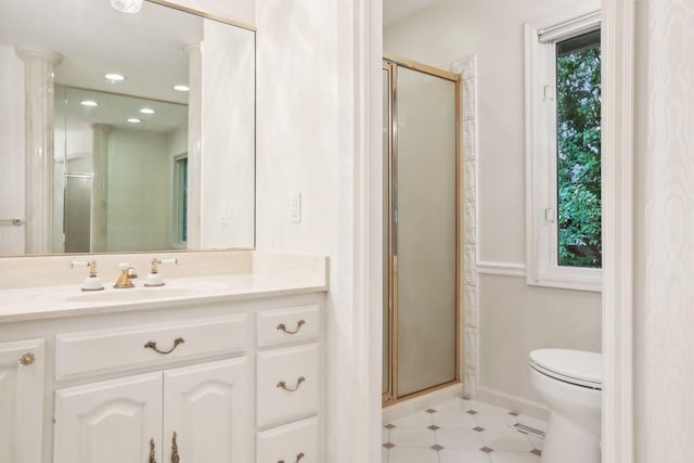 bathroom with vanity, a shower with shower door, and toilet