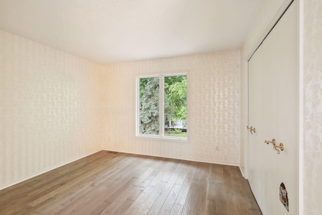 spare room with hardwood / wood-style floors