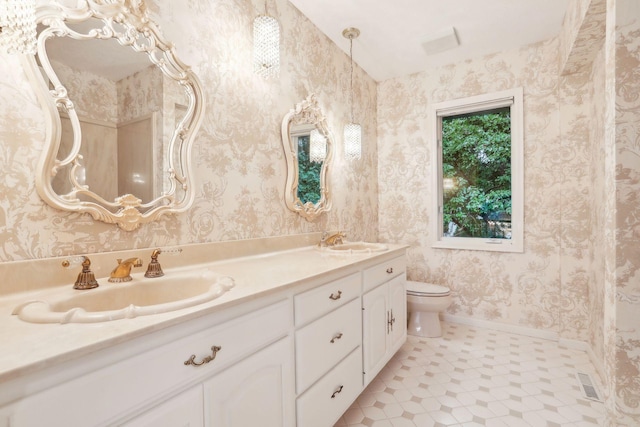 bathroom featuring vanity and toilet