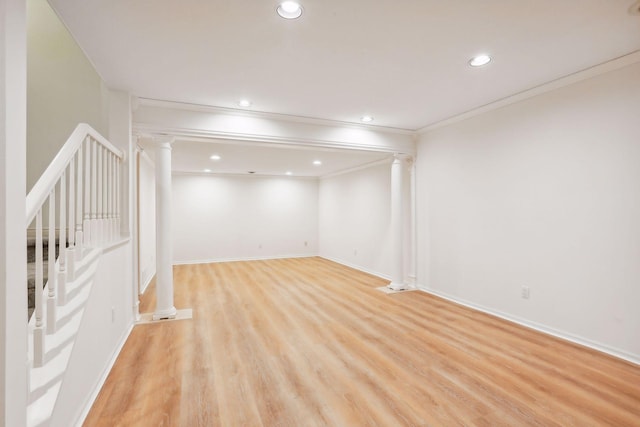 basement featuring ornamental molding and light hardwood / wood-style flooring