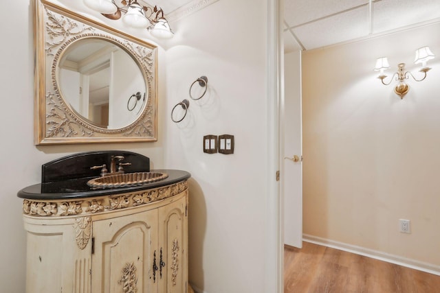 bathroom featuring vanity, hardwood / wood-style floors, and crown molding