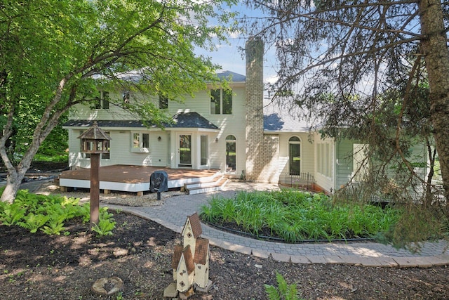 rear view of property with a wooden deck