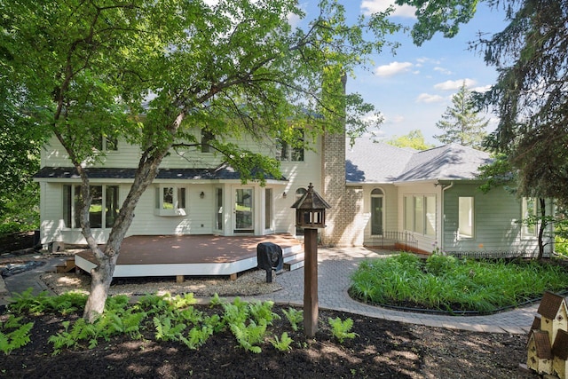 back of property featuring a wooden deck