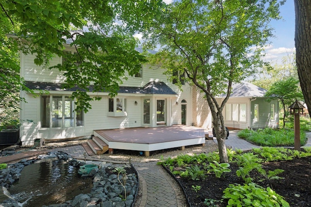 back of house with a wooden deck and central AC