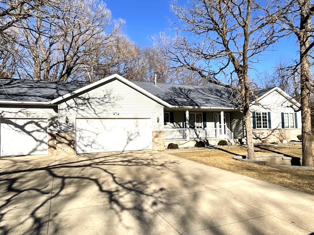 view of front of property with a garage and covered porch