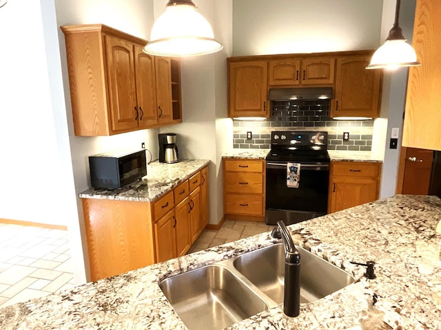 kitchen with pendant lighting, sink, backsplash, range with electric cooktop, and light stone counters