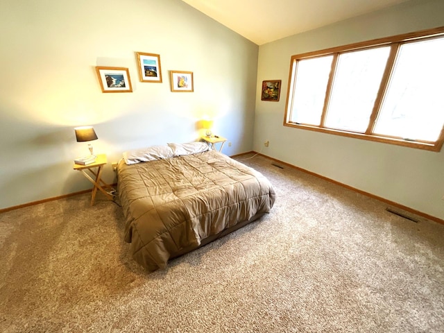 bedroom featuring lofted ceiling and carpet flooring