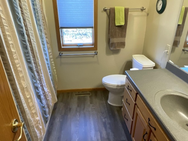 bathroom with vanity, hardwood / wood-style floors, and toilet