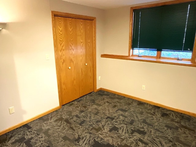 unfurnished bedroom featuring carpet and a closet