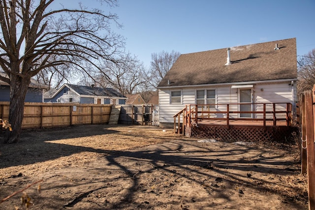 rear view of property with a wooden deck