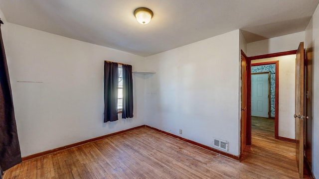 spare room with light hardwood / wood-style flooring