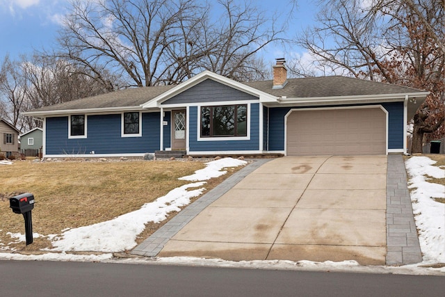 ranch-style house with a garage and a yard