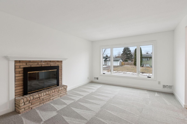 unfurnished living room featuring light carpet and a brick fireplace