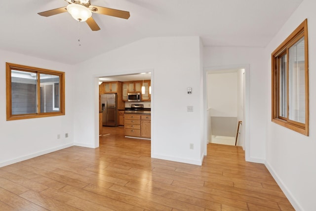 unfurnished living room featuring lofted ceiling, light hardwood / wood-style flooring, and ceiling fan