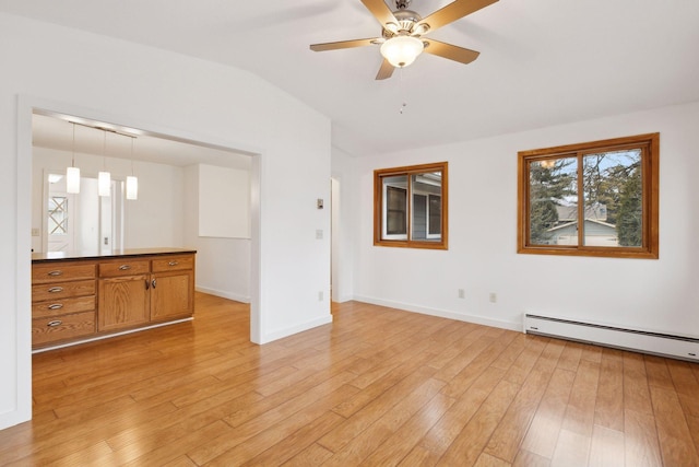 unfurnished living room featuring ceiling fan, vaulted ceiling, light hardwood / wood-style floors, and a baseboard radiator