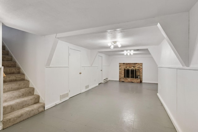 unfurnished living room with a fireplace and a baseboard radiator