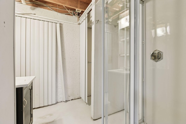 bathroom featuring vanity, concrete floors, and a shower with shower door