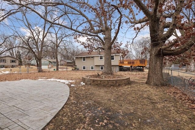 view of yard featuring a wooden deck and a patio