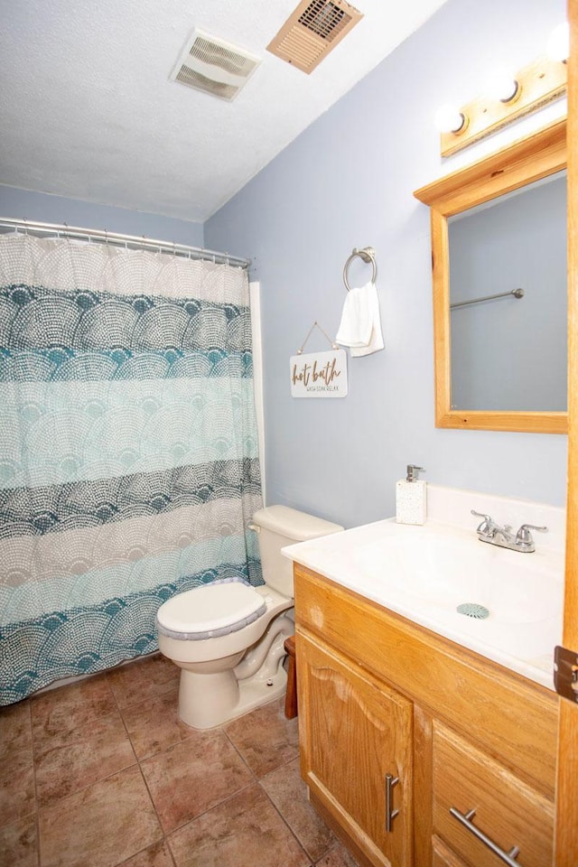 bathroom featuring tile patterned floors, vanity, and toilet