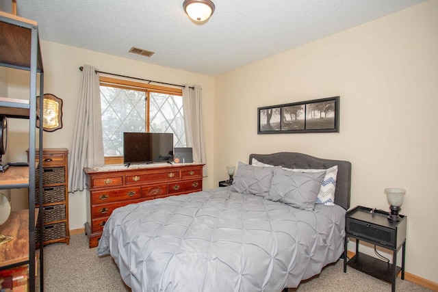 carpeted bedroom with a textured ceiling