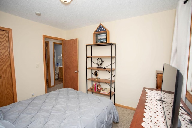 carpeted bedroom with a textured ceiling