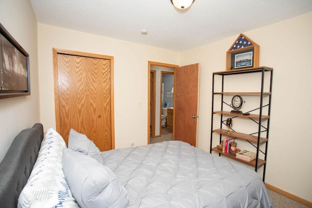 carpeted bedroom featuring a textured ceiling and a closet