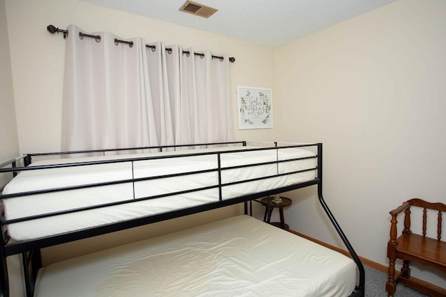 carpeted bedroom with a textured ceiling