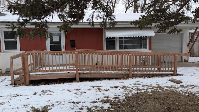 view of snow covered back of property