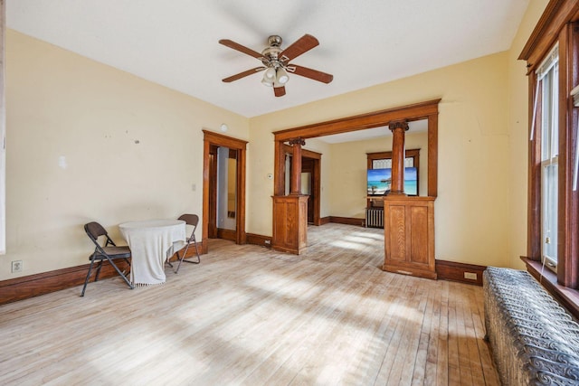 spare room with light wood-style floors, ceiling fan, and baseboards