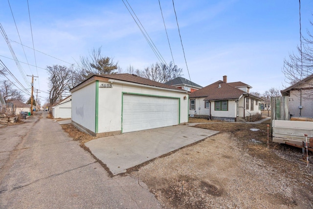 view of front of house with an outbuilding, driveway, and a garage