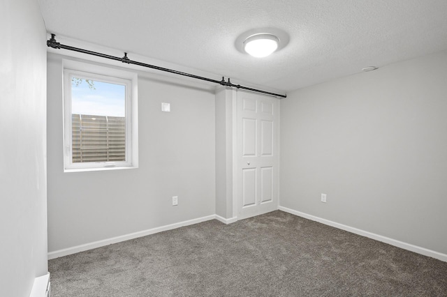 unfurnished bedroom with a textured ceiling and carpet