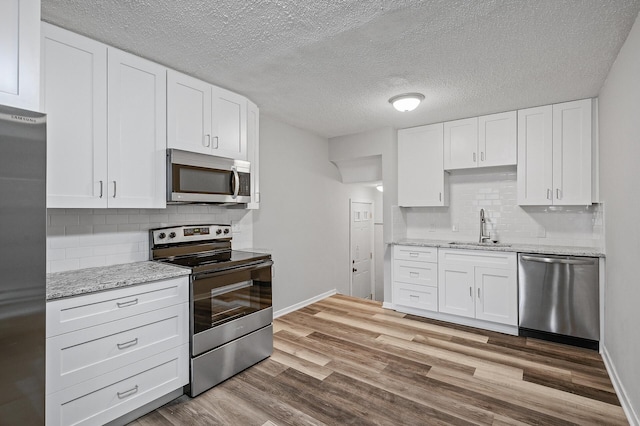 kitchen with white cabinetry, appliances with stainless steel finishes, and sink