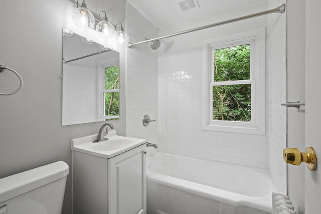 full bathroom with tiled shower / bath, vanity, toilet, and radiator heating unit