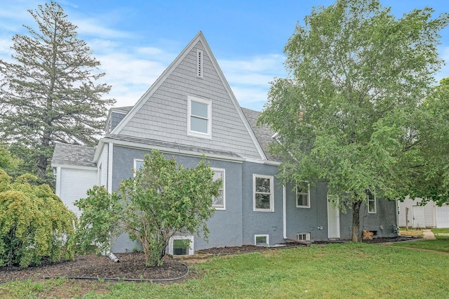 view of side of home with a yard