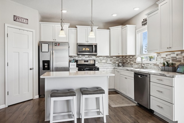 kitchen featuring white cabinetry, stainless steel appliances, and a center island