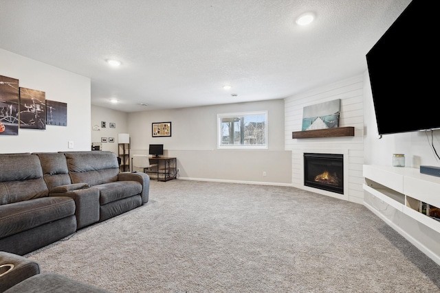 carpeted living room with a fireplace and a textured ceiling