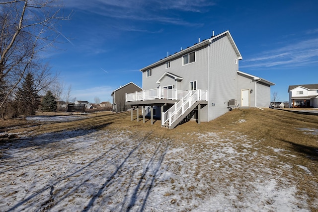 snow covered property with a deck and central air condition unit