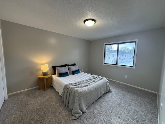 carpeted bedroom with a textured ceiling