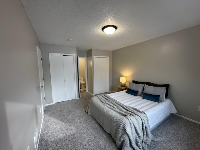 bedroom with multiple closets, connected bathroom, carpet, and a textured ceiling