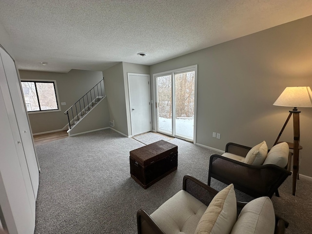 living room with light colored carpet and a textured ceiling