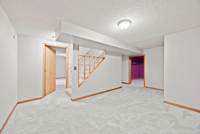 basement with light carpet and a textured ceiling